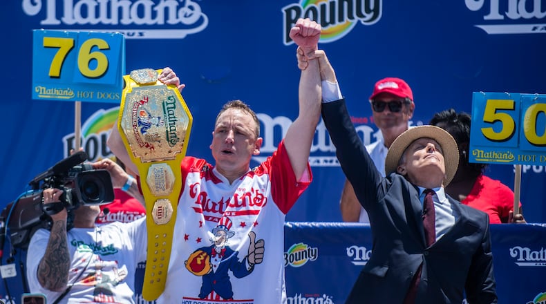 Chowdown champ Joey “Jaws” Chestnut celebrates after winning the the Nathan's Famous Fourth of July International Hot Dog-Eating Contest in Coney Island's Maimonides Park on Sunday, July 4, 2021, in the Brooklyn borough of New York. (AP Photo/Brittainy Newman)