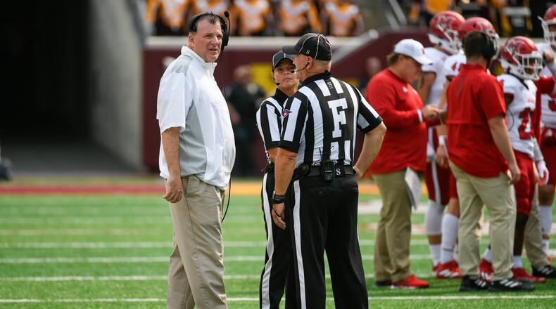 Miami-Ohio head coach Chuck Martin, left, talks with the game officials during a break in the first half of an NCAA college football game against Minnesota Saturday, Sept. 11, 2021, in Minneapolis. Minnesota won 31-26. (AP Photo/Craig Lassig)