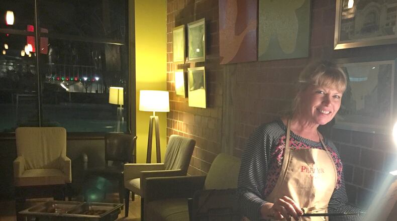 Artist Robine Wright is shown painting at Seasons restaurant in Springfield. Her artwork is currently being featured at the restaurant. SUBMITTED PHOTO