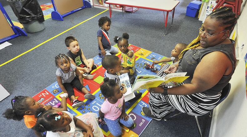 Danaye Scott, reads to her class Friday at the On Purpose Academy and Mentoring Center in Dayton. MARSHALL GORBYSTAFF