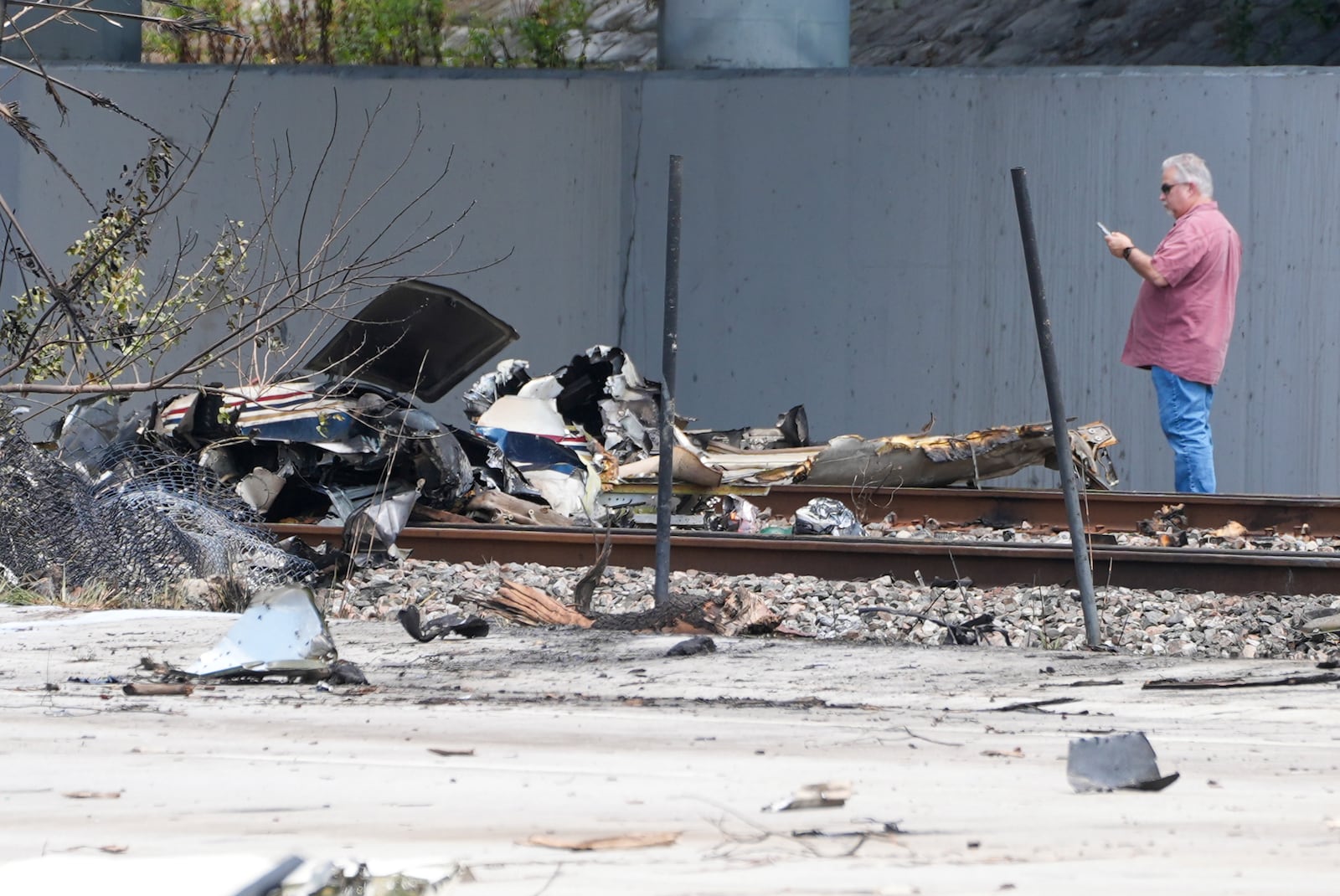 Emergency crew inspects the site of a small plane crash Friday, April 11, 2025 in Boca Raton, Fla. (AP Photo/Marta Lavandier)