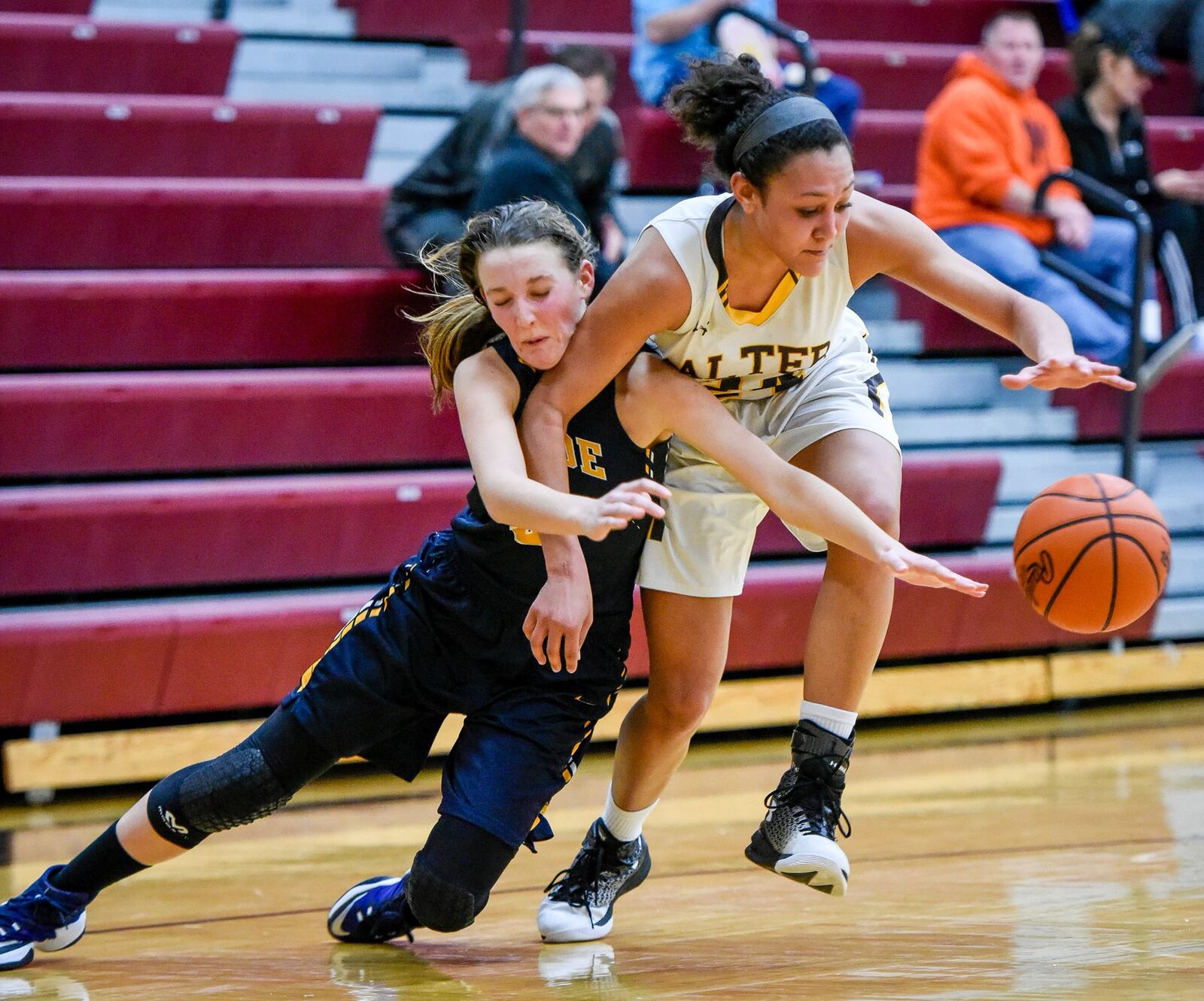 Monroe’s Kylee Slone (left) is called for a foul as she and Alter’s Braxtin Miller fight for a loose ball during their Division II sectional final Thursday night at Lebanon. NICK GRAHAM/STAFF