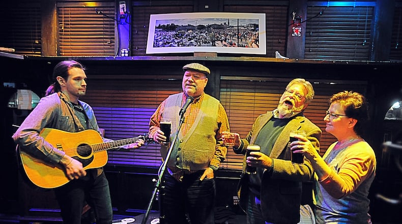 The group Jameson’s Folly played Irish tunes at the Dublin Pub Sunday night as the bar closed at 9 p.m. due to a order by Governor. MARSHALL GORBY/STAFF