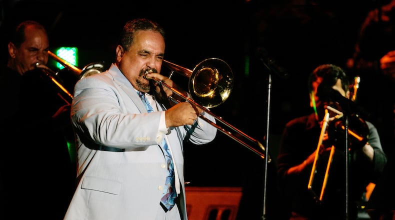 FILE - Willie Colon plays the trombone while performing the song "La Murga" during a tribute concert in honor of the late salsa music pioneer Hector Lavoe in San Juan, Puerto Rico, Sept. 7, 2007. Colón, considered by many to be the "architect of urban salsa," died Saturday, Feb. 21, 2026. He was 75. (AP Photo/Andres Leighton, File)