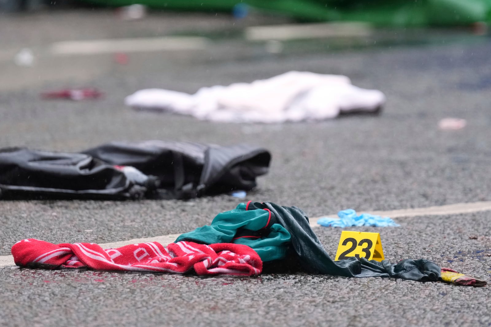 Evidence is marked near the site where a 53-year-old British man plowed a minivan into a crowd of Liverpool soccer fans who were celebrating the city's Premier League championship Monday, injuring more than 45 people in Liverpool, England, Tuesday, May 27, 2025.(AP Photo/Jon Super)