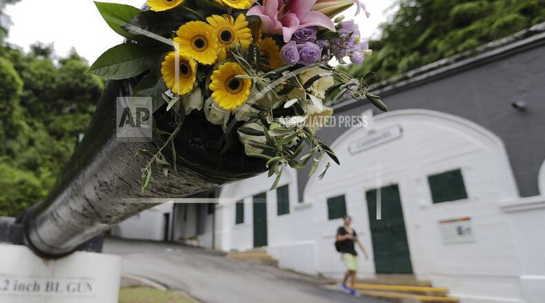 In this Saturday, June 9, 2018, photo, a World War II cannon is decorated with flowers to honor the historic meeting between U.S. President Donald Trump and North Korean leader Kim Jong Un on June 12, 2018. (AP Photo/Wong Maye-E)