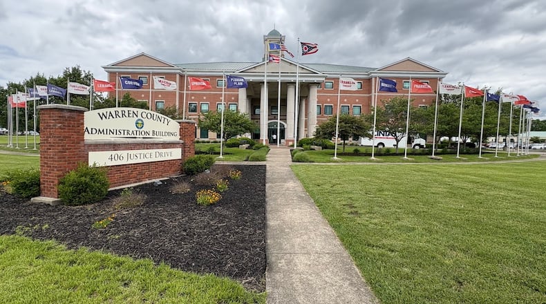 The American flag, Ohio flag and Warren County flags fly in front of the Warren County Administration Building, 406 Justice Drive in Lebanon, which also has flags for the cities, villages and townships on the grounds. JEN BALDUF/STAFF