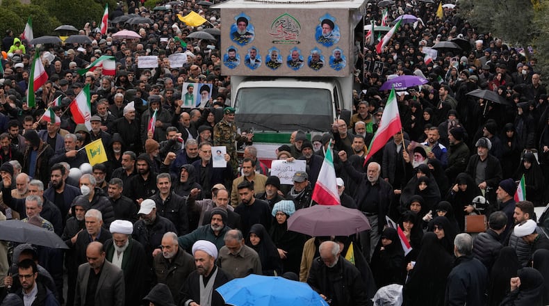Iranians follow a truck carrying the coffins of Iran's intelligence minister Esmail Khatib and, according to Iranian officials, his wife and daughter, during a funeral procession in Tehran, Iran, Friday, March 20, 2026. (AP Photo/Vahid Salemi)