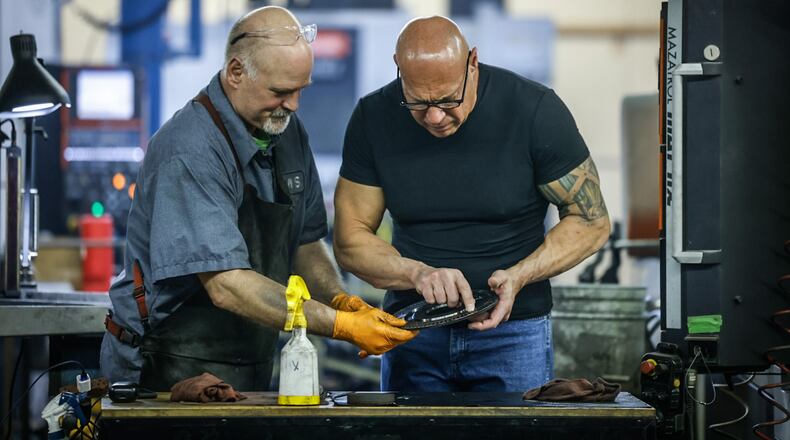 Johnson Manufacturing Systems machinist, John Noreland, left, works with owner, Tom Johnson in West Carrollton. The company is celebrating 20 years in business. JIM NOELKER/STAFF
