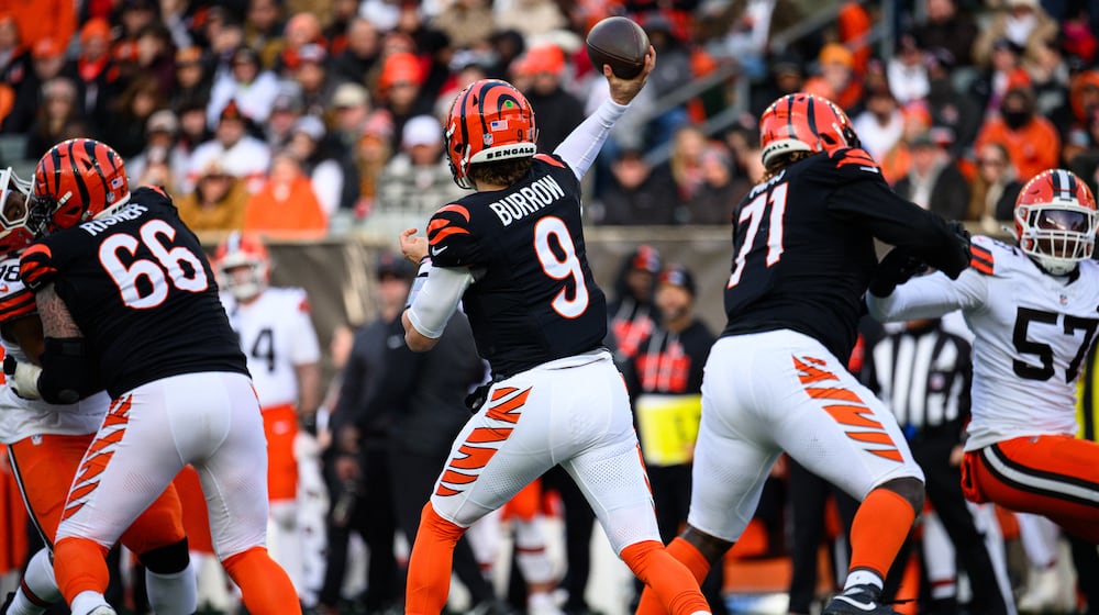Cincinnati Bengals quarterback Joe Burrow passes the ball with protection from offensive linemen Dalton Risner (left) and Amarius Mims during their game against the Cleveland Browns on Sunday, Jan. 4, 2026 at Paycor Stadium. JEREMY MILLER / CONTRIBUTED PHOTO