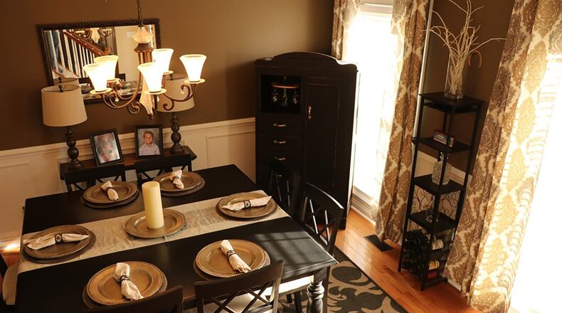 Wainscoting and a contemporary chandelier add a touch of elegance in the dining room.