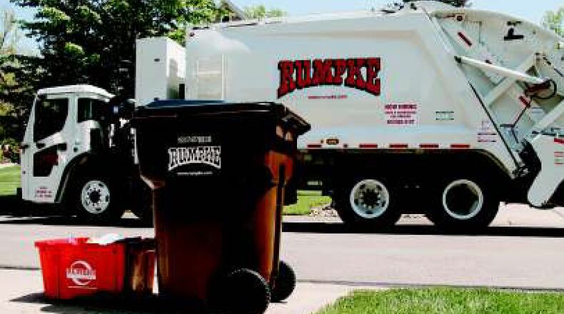 In this file photo, a Rumpke trash truck picks up a customer's trash and recycling in West Chester. FILE