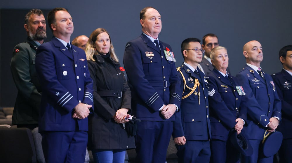 Forgein military officers from several countries, including Jody New (center left), a member of the Royal Australian Air Force, stand during a Veterans Day ceremony on Tuesday, Nov. 11 at Be Hope Church in Beavercreek. Officers from the Air Forces of Chile, Norway, Canada, Thailand, Spain, Poland and Japan were also in attendance. BRYANT BILLING/STAFF