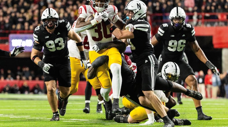 Southern California running back King Miller (30) carries the ball against Nebraska defensive back Rex Guthrie (21) during the second half of an NCAA college football game, Saturday, Nov. 1, 2025, in Lincoln, Neb. (AP Photo/Bonnie Ryan)