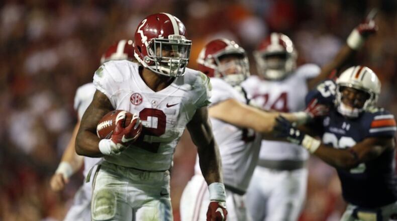 FILE - In this Nov. 28, 2015, file photo, Alabama running back Derrick Henry (2) runs the ball and scores a touchdown during the second half of an NCAA college football game against Auburn in Auburn, Ala. No. 2 Alabama's offensive methods have changed but the priority remains the same: Get the ball to the Crimson Tide's best player. Last year, that was Amari Cooper; now, clearly, it is Henry. (AP Photo/Gerald Herbert, File)