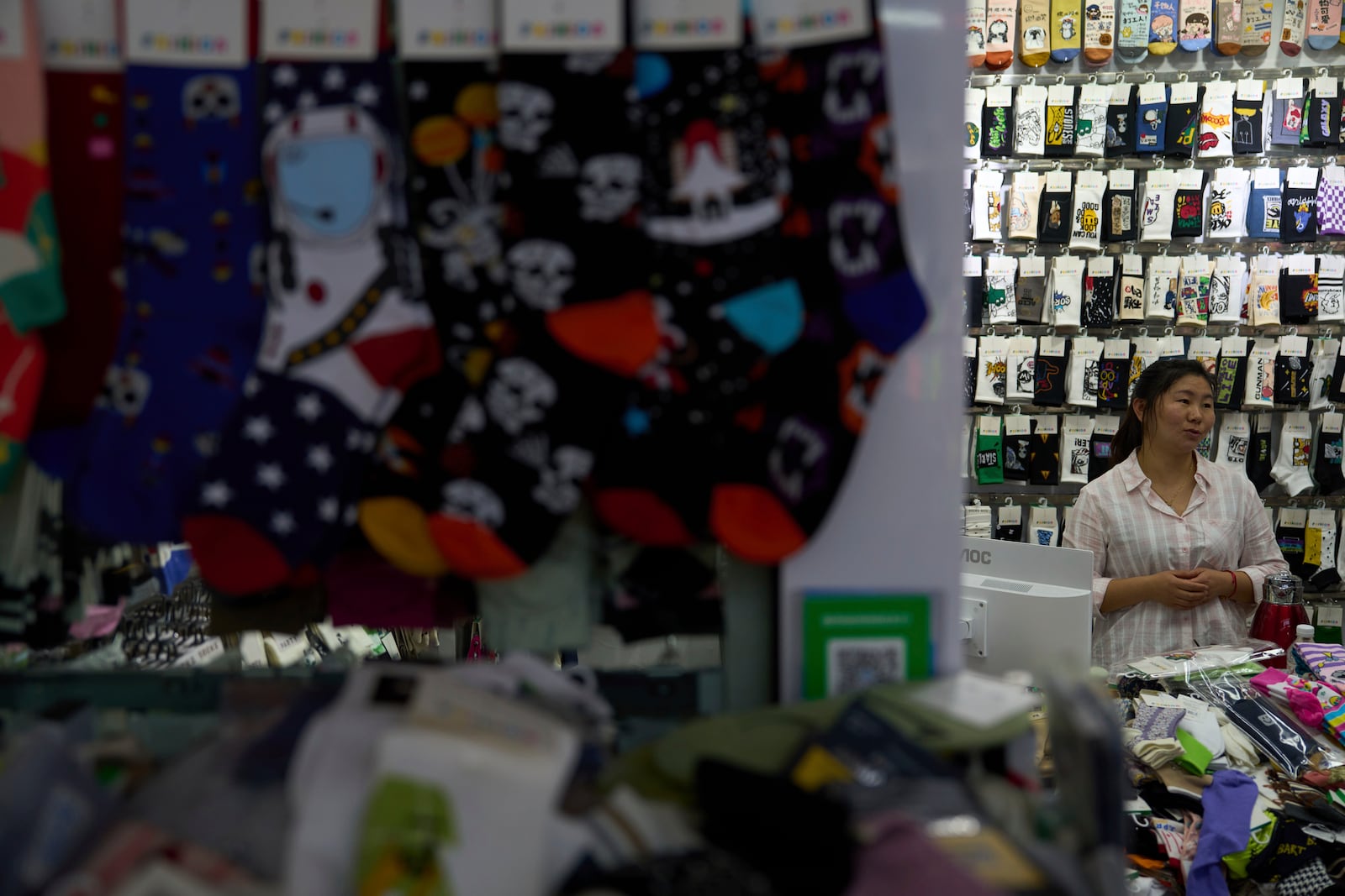 Wu Liying who runs the Xinyue Stockings Co. reacts at the Yiwu International Trade Market in Yiwu, eastern China's Zhejiang province on Thursday, April 10, 2025. (AP Photo/Ng Han Guan)