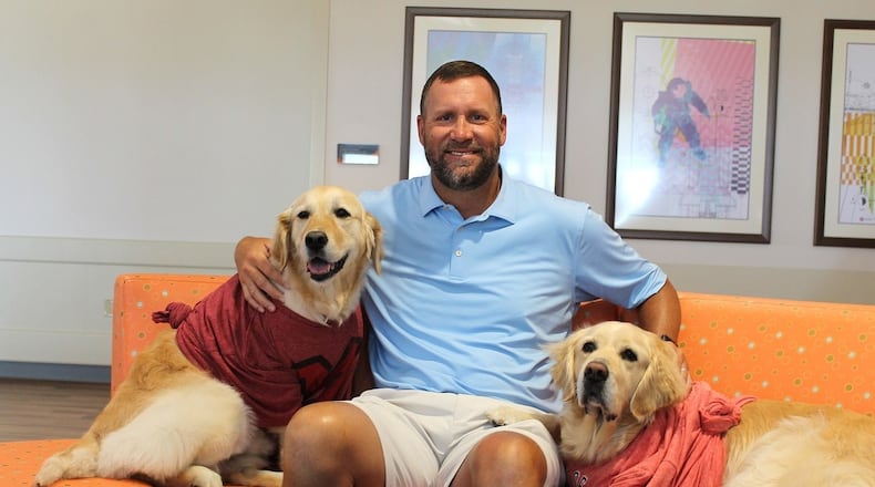 Ben Roethlisberger, a two-time Super Bowl champion and Findlay native, brought smiles and excitement to Dayton Children’s Hospital during a recent visit to the hospital. Roethlisberger is pictured here on Tuesday, June 24, 2025, with two of Dayton Children's hospital facility dogs, Millie and Peppermint. CONTRIBUTED