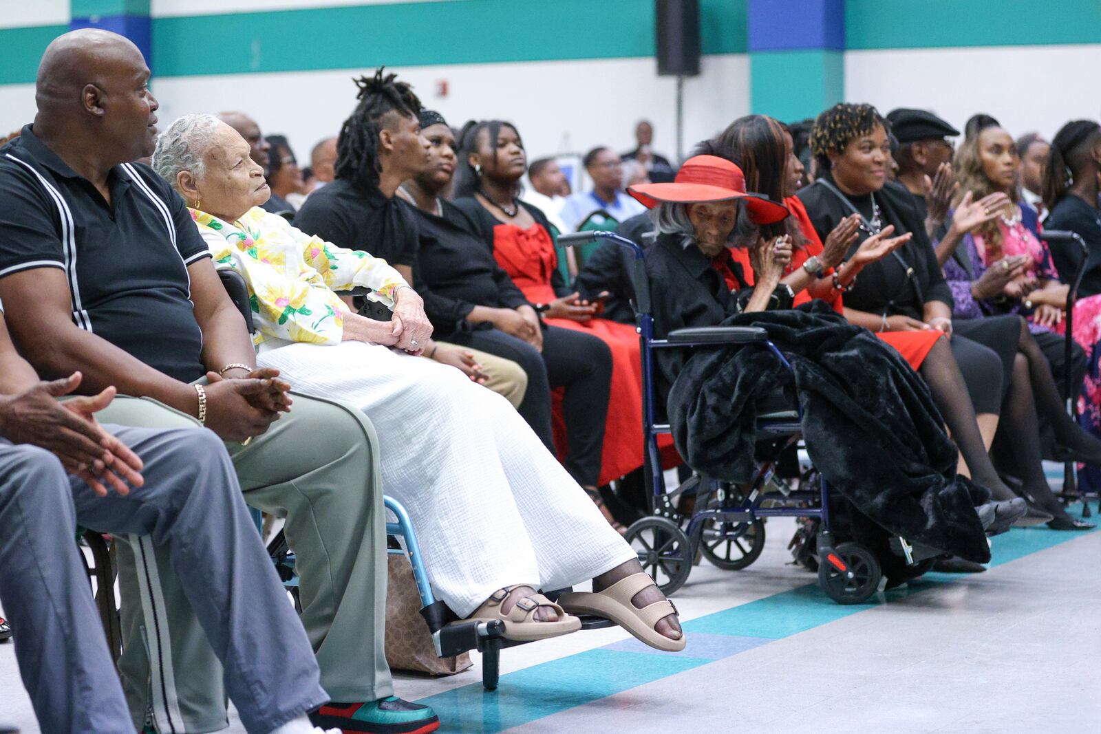 Viola "Mother" Ford Fletcher, 110 years of age (yellow) is one of the final two survivors sits across the aisle from the other survivor Lessie Benningfield "Mother" Randle (red hat), 109 years old, as they listen during the Legacy event for the Tulsa Race Massacre on Sunday, June 1, 2025, at Greenwood Cultural Center in Tulsa, Okla. (AP Photo/Joey Johnson)