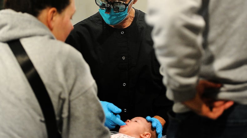Dr. Gregory Notestine examines a small patient, Emyrson Briggs of Franklin, Friday, Jan. 26, 2024 at PedZ Dental located at 5671 Far Hills Ave. MARSHALL GORBY\STAFF