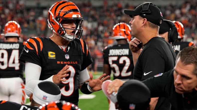 Cincinnati Bengals quarterback Joe Burrow (9) talks with head coach Zac Taylor, right, during the second half of an NFL football game against the Washington Commanders, Monday, Sept. 23, 2024, in Cincinnati. The Commanders won 38-33. (AP Photo/Jeff Dean)