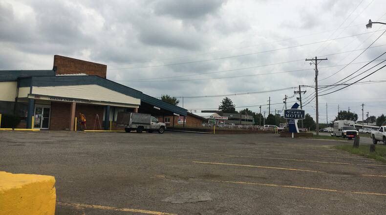 A motel and auto dealership along Ohio 4 in Hamilton. MIKE RUTLEDGE/STAFF