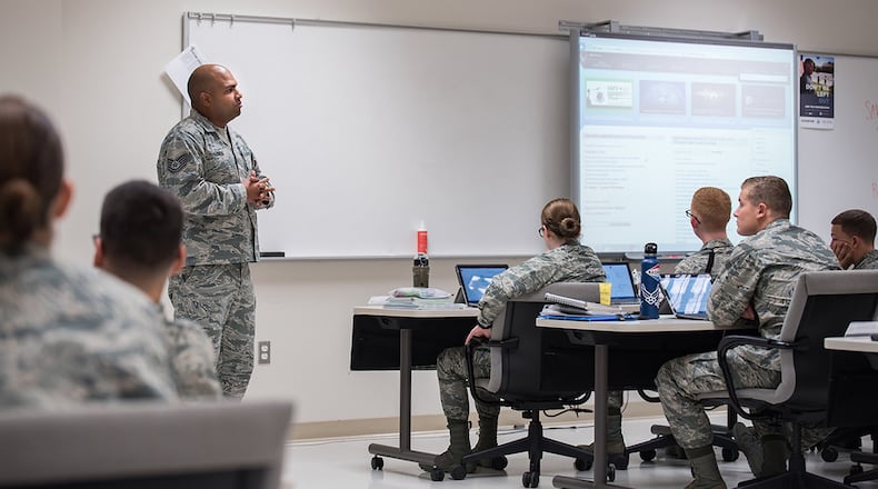 Tech. Sgt. Ricardo Lemos Rodriguez, NCO in charge of the Force Health Management Branch, mentors the Public Health apprentice students to prepare them for the operational Air Force. He discusses how they can navigate the Air Force Portal to locate information on Air Force priorities, career development and education. (U.S. Air Force photo/Richard Eldridge)