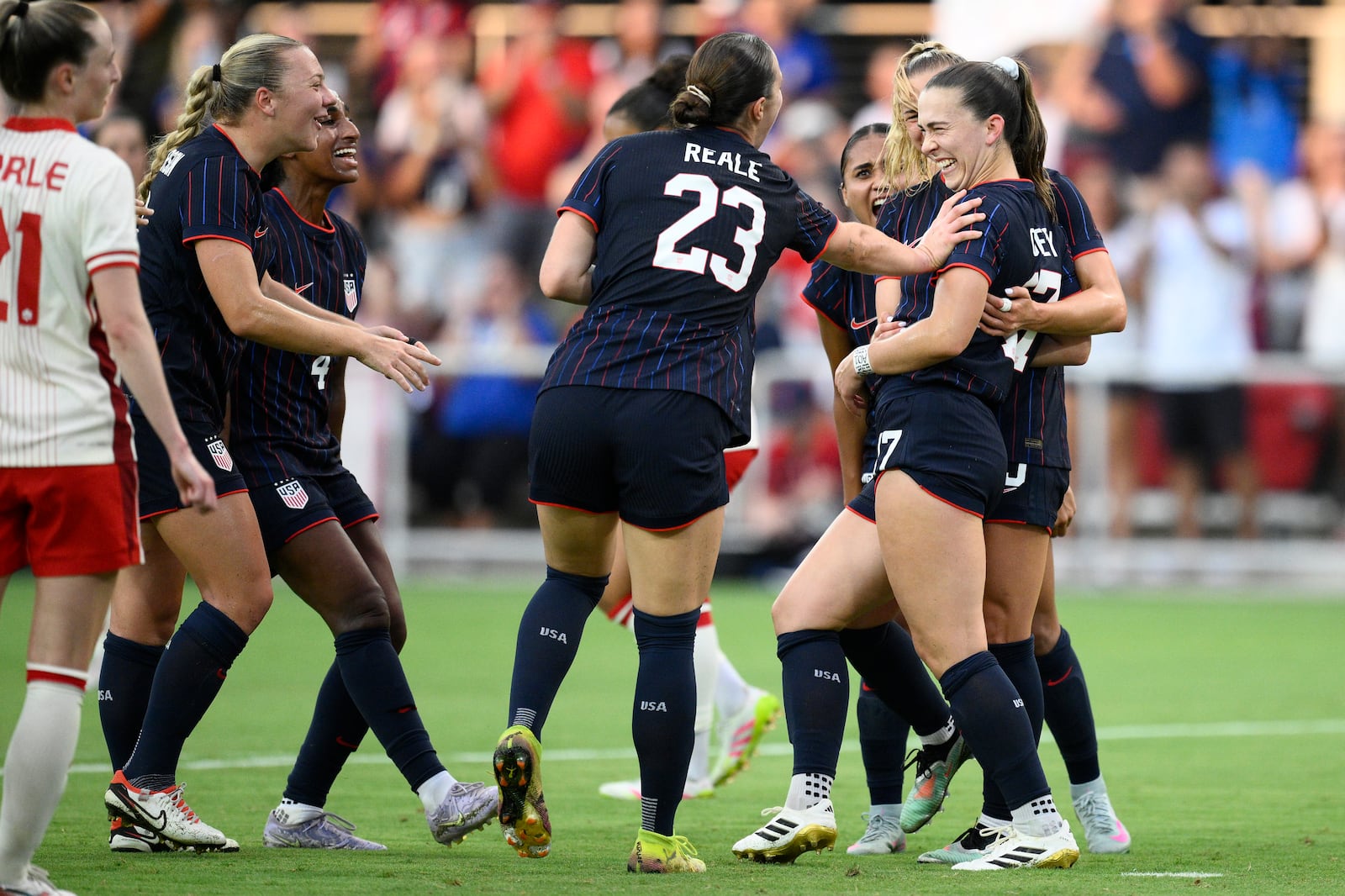 United States forward Sam Coffey, right, celebrates her goal with defender Lilly Reale (23) and others during the first half of an international friendly soccer match against Canada, Wednesday, July 2, 2025, in Washington. (AP Photo/Nick Wass)