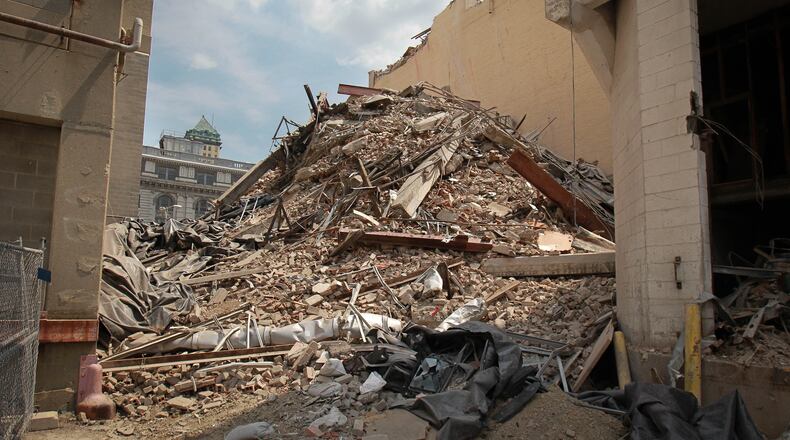 Workers begin demolishing the former Dayton Daily News building on 4th and Ludlow Streets Tuesday August 20, 2013. The historic portion will be saved, and apartments will be constructed in the future at the site