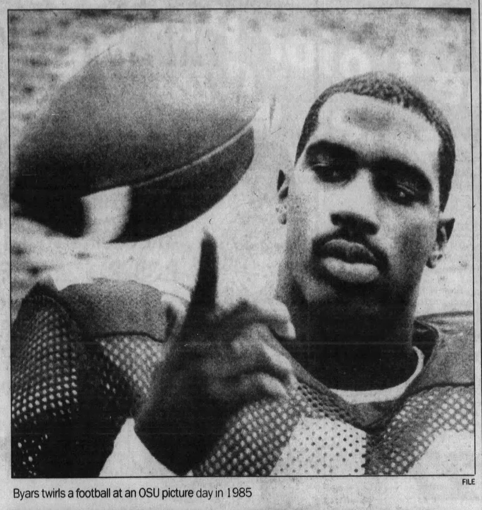 Keith Byars twirls a football at an Ohio State picture day in 1985. DAYTON DAILY NEWS ARCHIVES.