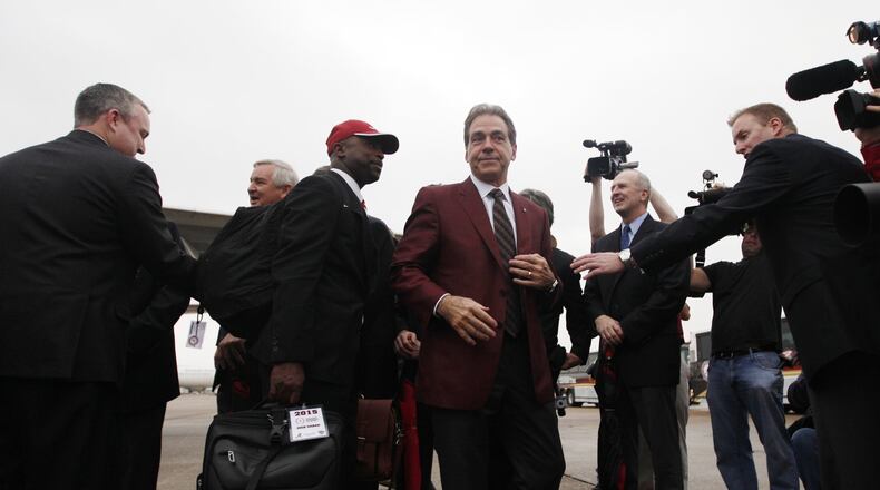 Alabama coach Nick Saban arrives with his team at Louis Armstrong New Orleans International Airport on Saturday, Dec. 27, 2014, in New Orleans. David Jablonski/Staff
