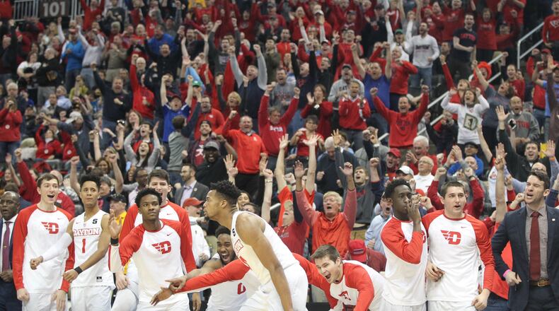 Dayton's Charles Cooke makes a go-ahead pointer in the final minutes against Davidson in the quarterfinals of the Atlantic 10 tournament on Friday, March 10, 2017, at PPG Paints Arena in Pittsburgh. David Jablonski/Staff
