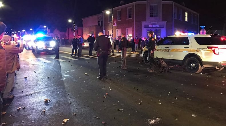 Yellow Springs police are seen early New Year’s Day after an apparent clash with revelers following an annual ball drop event in the village. MARGARET KINNER FISCHER / CONTRIBUTED