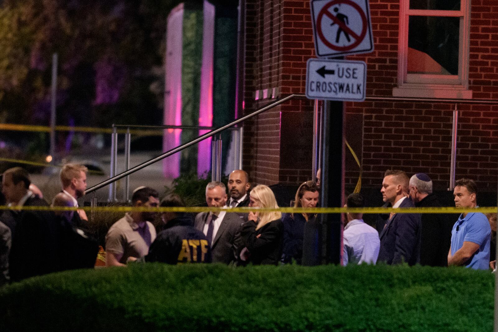 Attorney General Pam Bondi, center, walks to her car as law enforcement work the scene after two staff members of the Israeli Embassy in Washington were shot and killed outside the Capital Jewish Museum, Thursay, May 22, 2025, in Washington. (AP Photo/Rod Lamkey, Jr.)