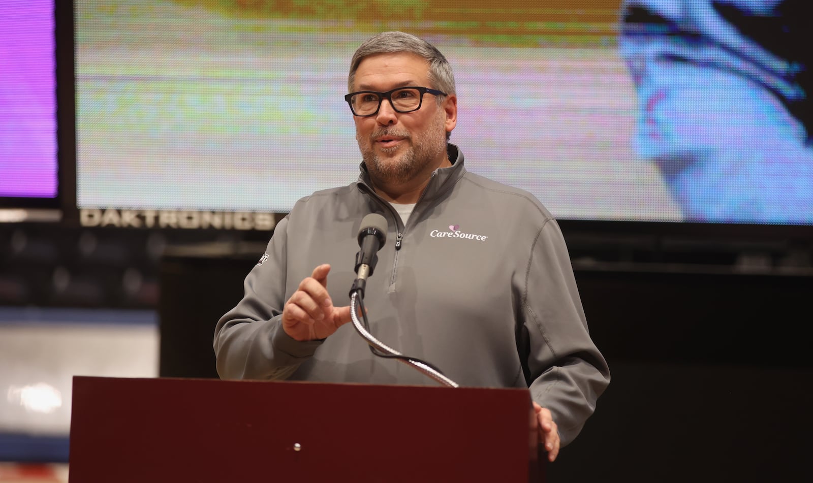 Scott Markovich, of CareSource, speaks at The Spotlight Town Hall, a mental health event, on Wednesday, Oct. 9, 2024, at UD Arena in Dayton. David Jablonski/Staff
