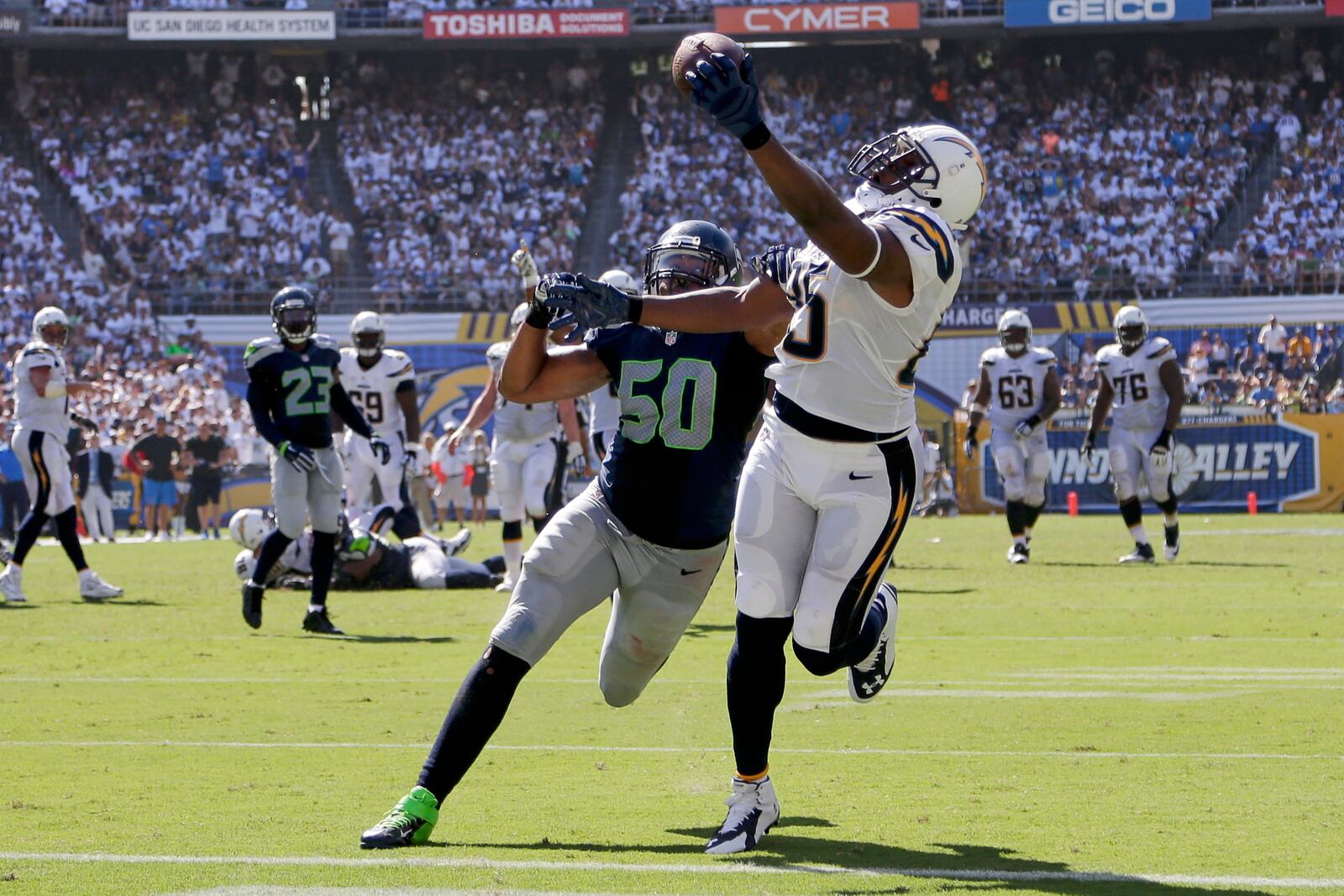 FILE - San Diego Chargers tight end Antonio Gates hauls in a touchdown catch as Seattle Seahawks outside linebacker K.J. Wright defends during the second half of an NFL football game, Sunday, Sept. 14, 2014, in San Diego. (AP Photo/Gregory Bull, File)