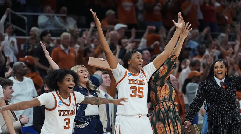 Texas guard Rori Harmon (3) and forward Madison Booker (35) celebrate their win over Oregon in the second round of the NCAA college basketball tournament, Sunday, March 22, 2026, in Austin, Texas. (AP Photo/Eric Gay)