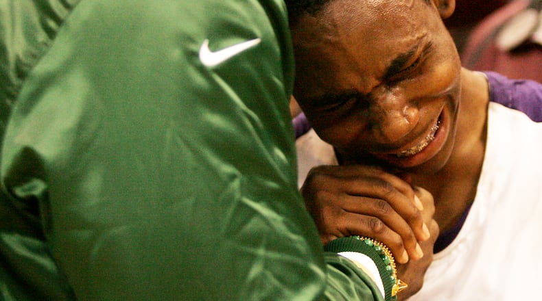Thurgood Marshall’s Juwan Staten is comforted by Cleveland Cavalier star and Akron St. Vincent-St. Mary alum LeBron James following their 59-53 loss in the D-II state championship finals in 2009. Staff Photo by Jim Witmer