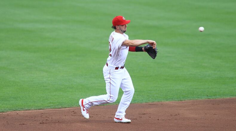 Reds shortstop Kyle Farmer makes a throw against the Royals on Tuesday, Aug. 11, 2020, at Great American Ball Park in Cincinnati. David Jablonski/Staff