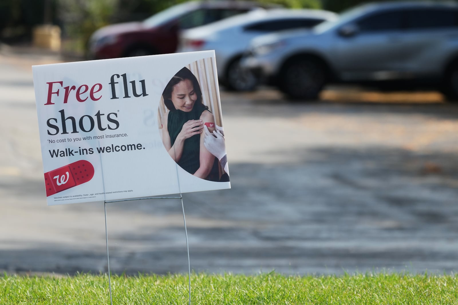A sign for flu shots is displayed outside a Walgreens in Wheeling, Ill., Tuesday, Sept. 23, 2025. (AP Photo/Nam Y. Huh)