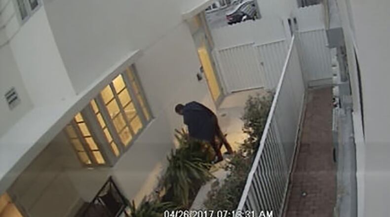 Surveillance footage shows a hotel employee shooting a cat with a crossbow (WPLG)