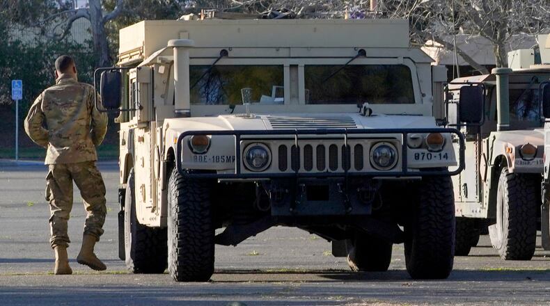 California National Guard vehicles are parked at the California State Fair and Exposition grounds, where they can be deployed to the state Capitol or other government buildings in the area, Tuesday, Jan. 19, 2021, in Sacramento, Calif. California Gov. Gavin Newsom mobilized the National Guard last week and over concerns that protests around Wednesday's inauguration of President-elect Joe Biden could turn violent and destructive. (AP Photo/Rich Pedroncelli)