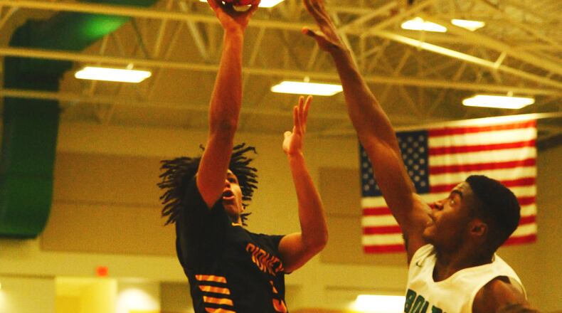 Sidney’s Darren Taborn gets a shot off over Northmont’s Ifeanyi Nwanoro. Sidney defeated host Northmont 72-68 in a boys high school basketball game on Tuesday, Jan. 15, 2019. GREG BILLING / CONTRIBUTED