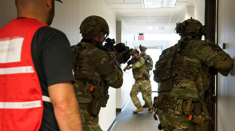 Defenders from the 88th Security Forces Squadron clear a hallway during an active-shooter exercise Aug. 10 at Wright-Patterson Air Force Base. The exercise was conducted to test the skills of first responders in a potential real-world scenario. U.S. AIR FORCE PHOTO/JAIMA FOGG