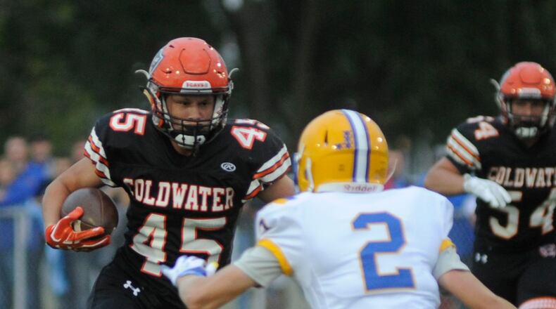 Coldwater’s Caleb Dippold (with ball) is met by Marion Local defender Tyler Prenger in the first half. MARC PENDLETON / STAFF