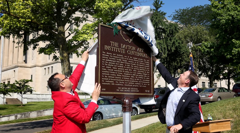 Michael Roediger, director and CEO of the Dayton Art Institute (left), and Brock Anderson III, chair of the board of trustees, unveil an Ohio Historical Marker commemorating the 100th year of the Dayton Art Institute on Tuesday, July 2. LISA POWELL / STAFF