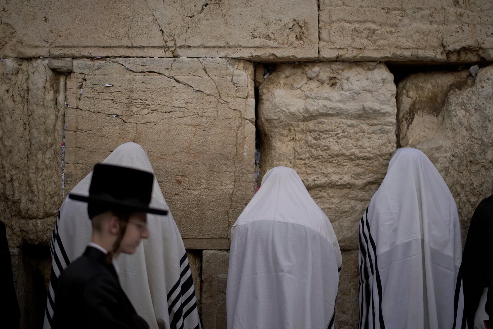 Covered in prayer shawls, Jewish men of the Cohanim Priestly caste participate in a blessing during the holiday of Passover, at the Western Wall, the holiest site where Jews can pray, in the Old City of Jerusalem, Tuesday, April 15, 2025. (AP Photo/Leo Correa)