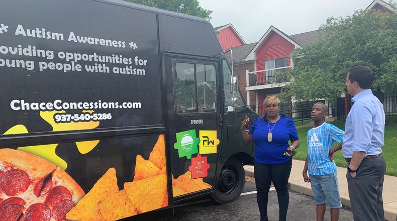 Tae Winston (left) and her son Chace show Ohio Secretary of State Frank LaRose the food truck Winston opened to raise awareness about autism, and provide jobs to autistic people like Chace. LaRose visited Dayton to talk about how the state can support minority-owned businesses.