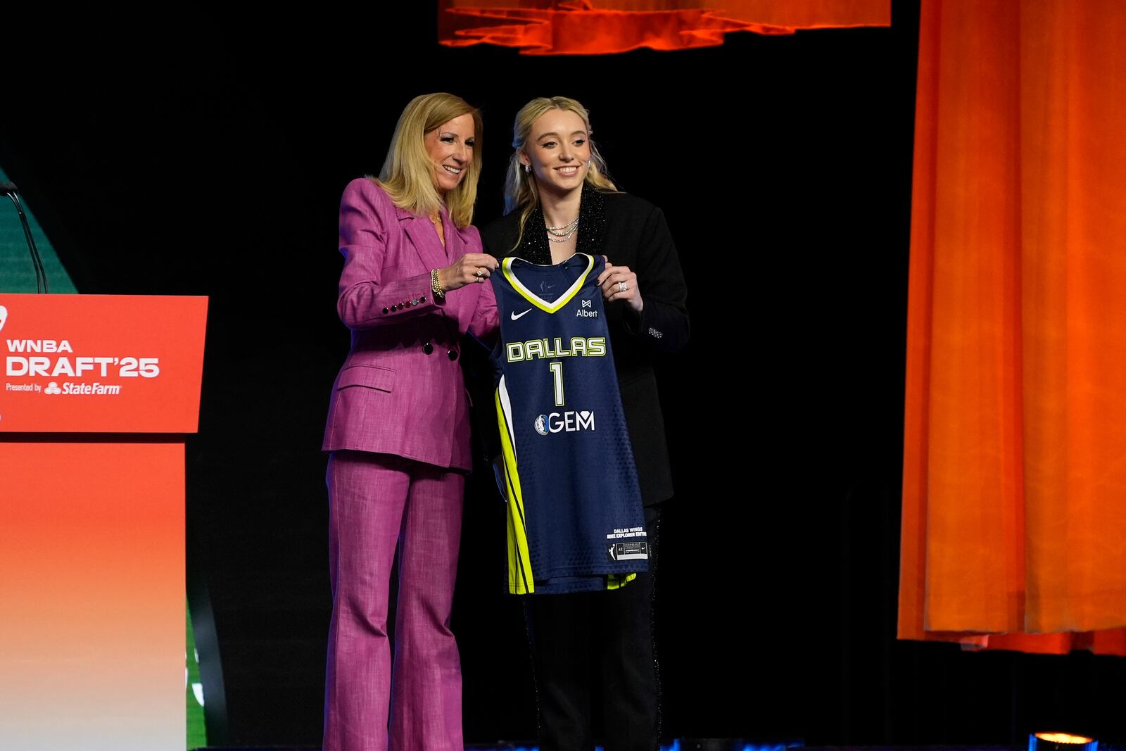UConn's Paige Bueckers, right, poses for a photo with WNBA commissioner Cathy Engelbert after being selected first overall by the Dallas Wings during the first round of the WNBA basketball draft, Monday, April 14, 2025, in New York. (AP Photo/Pamela Smith)