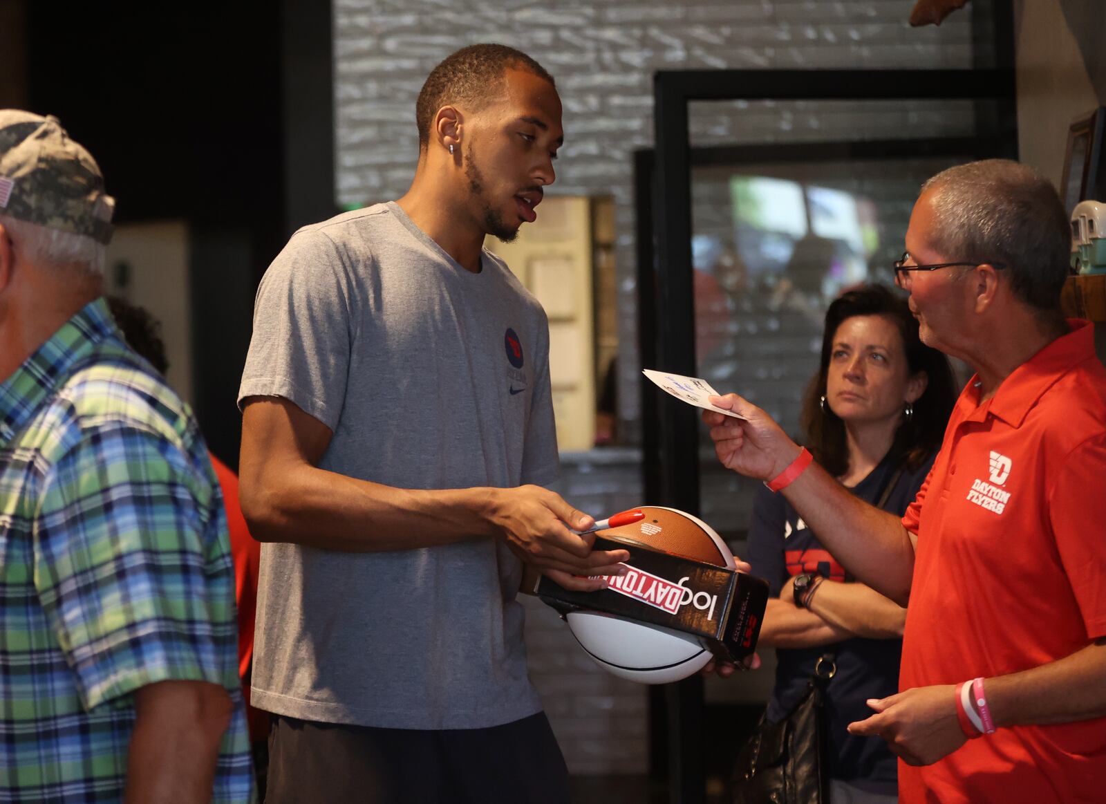 Dayton's Zed Key signs an autograph for a fan at a Dayton 6th meet and greet at Warped Wing Barrel Room and Smokery on Monday, June 17, 2024, in Springboro. David Jablonski/Staff