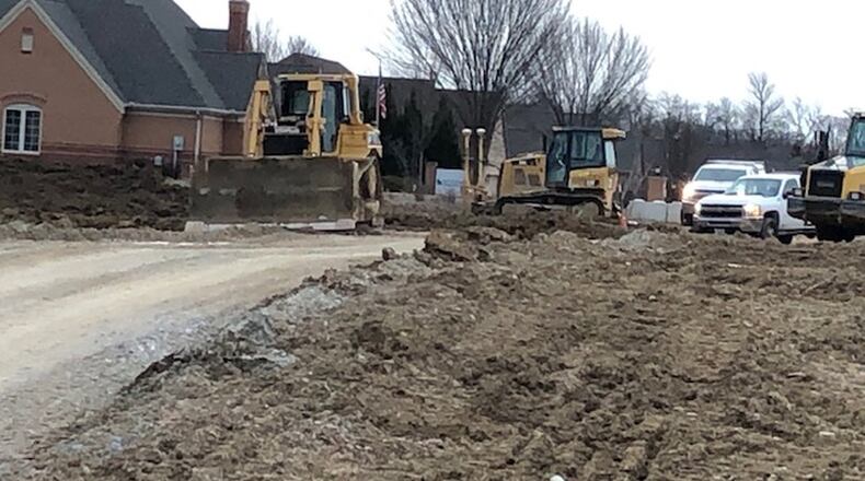 Crews work at the west end of Vienna Parkway, where Miami Twp. officials have approved extending the road 650 feet to Ohio 741. The new intersection will include a new traffic signal. NICK BLIZZARD/STAFF